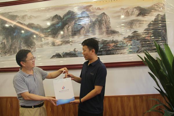 曾经的年级长为学生代表赠送礼物